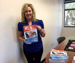 Volunteer holding up an RLS flyer - Restless Legs Syndrome Foundation