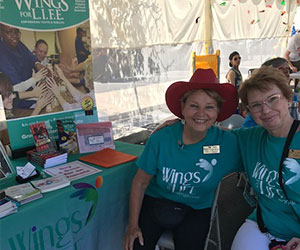 Volunteers at their organization booth - Wings For Life International 