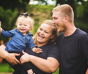 Parents smiling at their daughter - Nurse Family Partnership