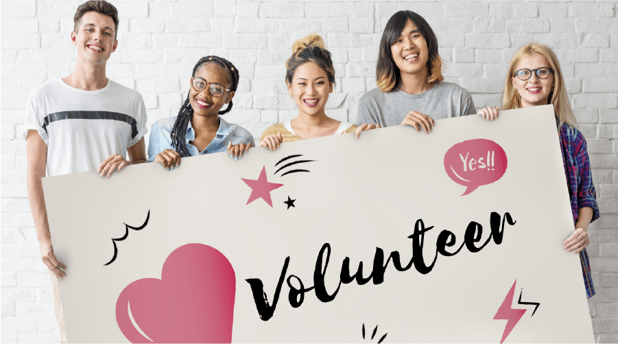 5 teenagers holding a sign that says Volunteer