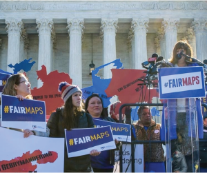 Group of people outside the U.S. Supreme court holding Anti Gerrymandering signs
