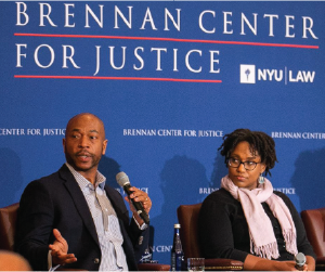 group of people speaking at a conference