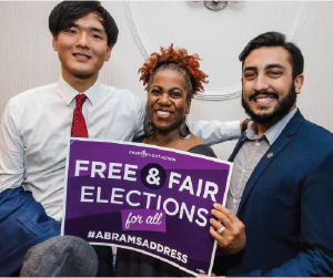 three diverse people holding a sign that says Free & Fair Elections for all