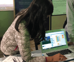 girl showing her project on laptop