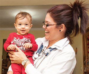 a doctor and her toddler patient - Medical Education Cooperation With Cuba