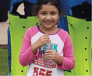 girl at a marathon posing proud