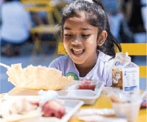 girl happily looking at food