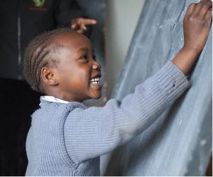 girl writing on chalkboard