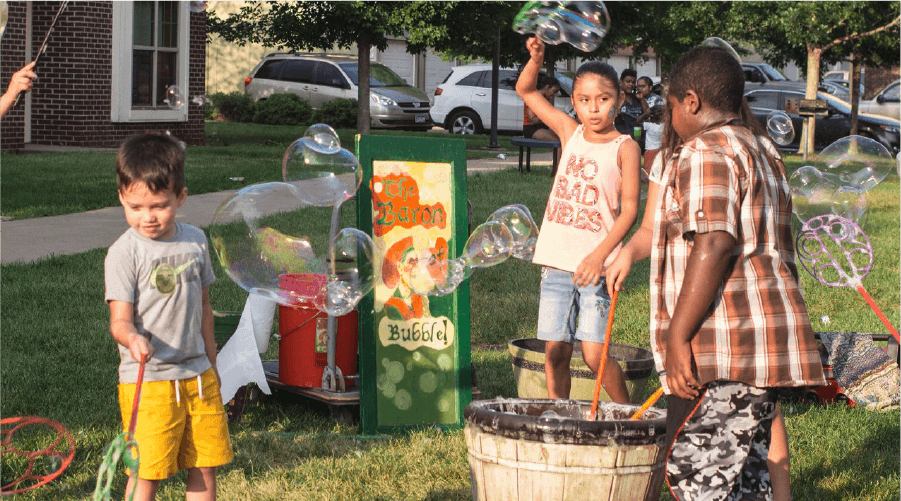 kids playing with bubbles in their neighborhood