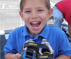 Little girl holding her new shoes Goodie Two Shoes Foundation