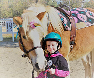 little girl and her mare M-A-R-E-Riding-Center