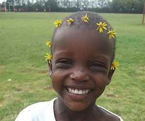 Little girl with flower on her head Bread and Water for Africa