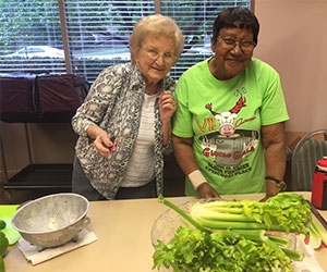 Volunteer helping prepare meals Episcopal Communities Foundation