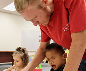 program coordinator with little boy Nevada Blind Childrens Foundation