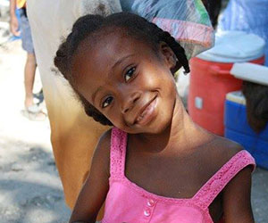 Little Haitian girl smiling Health Ministries for Haiti Inc