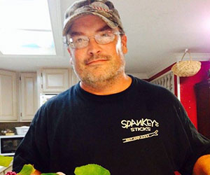 Volunteer holding up produce Florida Urban Agriculture Inc.