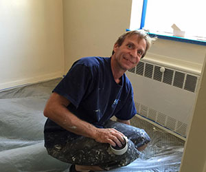 Volunteer painting a room The INN Between