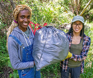 two volunteers clearing out trash at forest clean up Los Padres Forestwatch