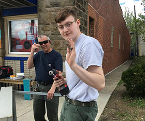 volunteer helping build a little library Brookline Teen Outreach