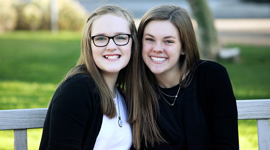 two young women smiling together